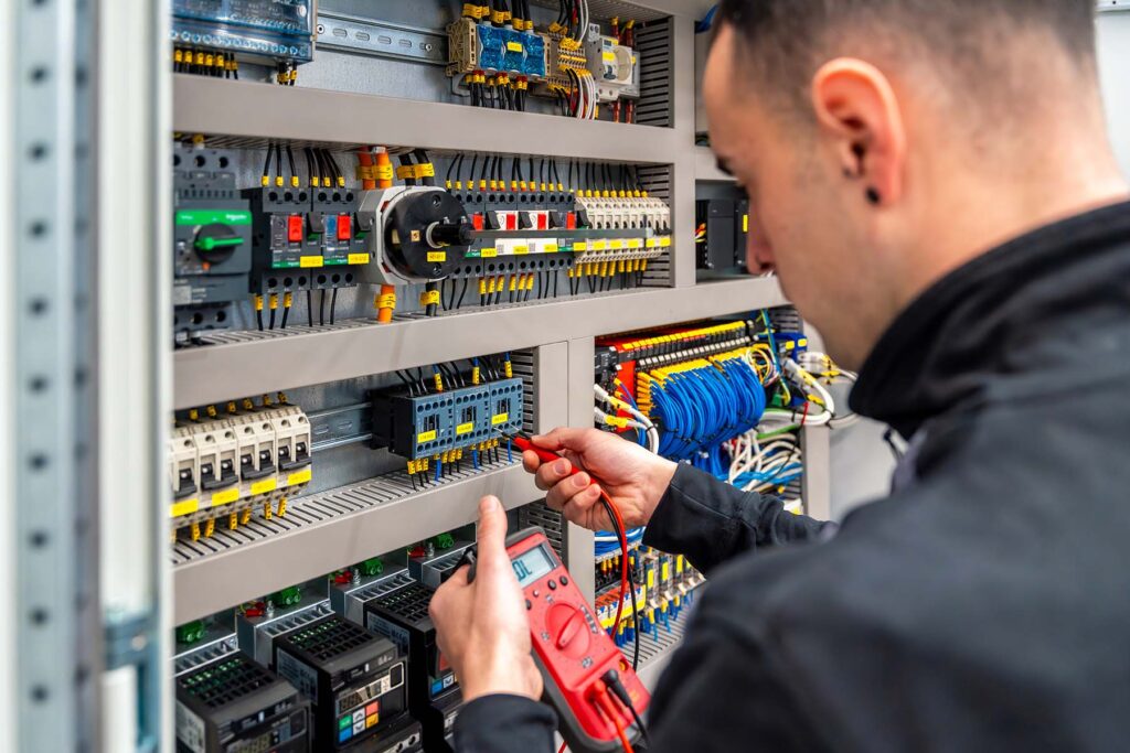 close up of an engineer repairing an electrical sy swke5hu.jpg